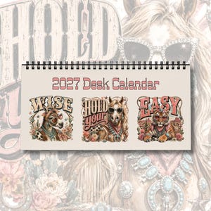 May include: A 2027 desk calendar with a spiral binding, featuring a beige background and three illustrations. The text reads 2027 Desk Calendar, Wise, Hold Your, and Easy. The images depict a donkey, a horse, and a tiger wearing western-style jewelry.