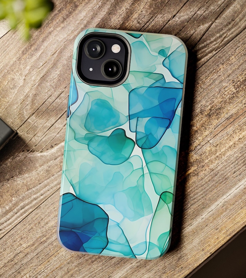 May include: A clear phone case with a blue and green abstract design. The case has a camera cutout for a dual-lens camera.