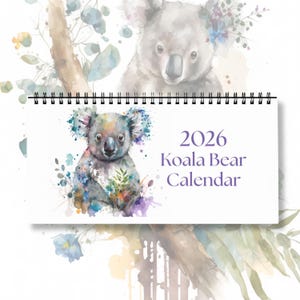 May include: A spiral-bound 2026 Koala Bear Calendar. The calendar features a watercolor illustration of a koala bear with colorful accents. The background includes a larger, faded koala image and floral elements.