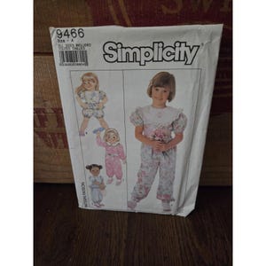 May include: A vintage Simplicity sewing pattern packet featuring illustrations of children's clothing. The packet includes the number 9466 and the words "All Sizes Included". The clothing designs include a romper, jumpsuit, and dress.