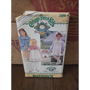 May include: Vintage Butterick sewing pattern for Cabbage Patch Kids outfits. The package features illustrations of children in dresses, with the Cabbage Patch Kids logo and the number 3086. The size range is 2-3-4.