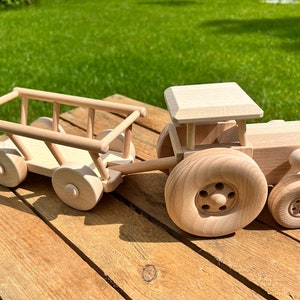 Natural wooden tractor with its trailer