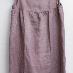 Puede incluir: Un vestido de lino malva con cuello redondo y mangas con volantes.