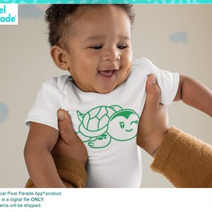 May include: A white baby onesie featuring a green cartoon turtle design. The turtle has a smiling face and a winking eye. The onesie is being held by a person's hand.