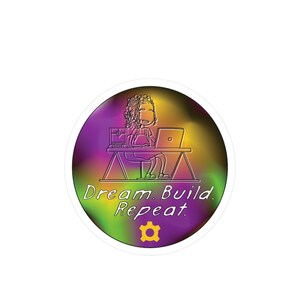 May include: A colorful sticker with a cartoon illustration of a person sitting at a desk with a laptop and a 3D printer. The text "Dream. Build. Repeat." is written below the illustration. A gear icon is at the bottom of the sticker.