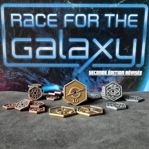 May include: A close-up of game pieces for the board game Race for the Galaxy: Second Edition Revised. The pieces are made of metal and feature different colours and designs. The game pieces include a gold-coloured 10-point token, silver-coloured 5-point tokens, and copper-coloured tokens with an atom symbol.