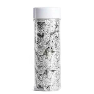 May include: A clear plastic jar with a white lid filled with silver leaf flakes.