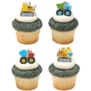 May include: Four cupcakes decorated with construction vehicle toppers. The cupcakes are frosted with white frosting and have a gray sprinkle topping. The toppers are a yellow bulldozer, a green dump truck, a red cement mixer, and a yellow excavator.