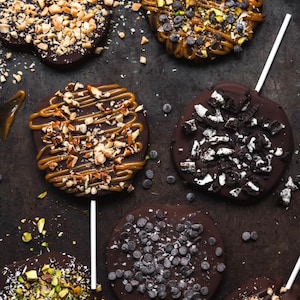 Chocolate covered apple slices on a stick
