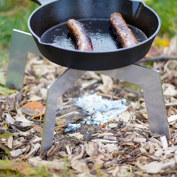 Firepit trivet pot stand. Stainless. A portable collapsible campfire cooking pot stand and grate. Use on coals with pans and Dutch ovens.