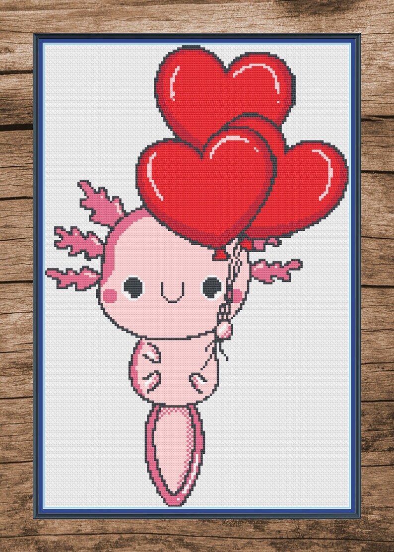 Puede incluir: Un ajolote rosa con una cara linda sostiene tres globos rojos en forma de coraz&oacute;n. El ajolote tiene una cola larga y branquias plumosas.