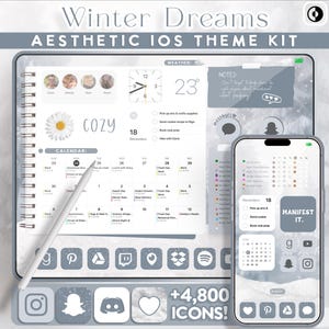 May include: Aesthetic iOS theme kit with a winter theme. The image shows a digital planner and a smartphone with a matching interface. The planner displays a calendar, weather information, and reminders. The smartphone shows a calendar and app icons. The text includes "Winter Dreams" and "COZY".