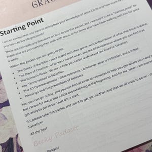 May include: A printed document titled "LIVING LIFE GRACIOUSLY" with the subtitle "Starting Point." The document includes text about the Bible, salvation, and related topics. The document is on a floral patterned surface.