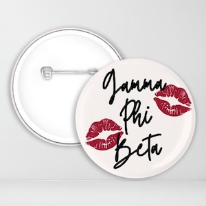 May include: White button with a black and red design. The button features the text "Gamma Phi Beta" and three red lips.