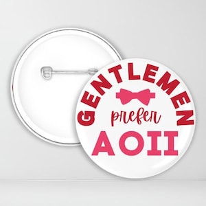 May include: A white button with a red border and the text "Gentlemen prefer A". A pink bow tie is above the text.