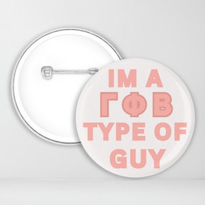 May include: A white button with a pink design that says "I'm a ΓΦΒ type of guy".
