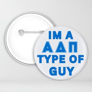 May include: A white button with a blue pin back. The button has the text "IM A A A P TYPE OF GUY" in blue letters.
