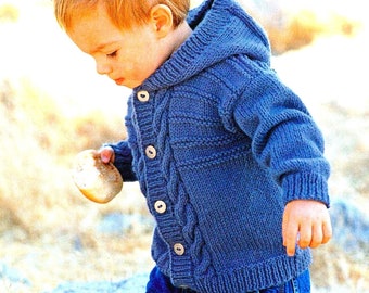 May include: A blue knitted hooded cardigan with a cable knit pattern and button closure. The cardigan is worn by a child standing on a log.