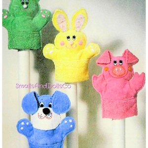 May include: A white ceramic mug with a black handle and the text "But First, Coffee" in a bold, black font. The mug is set against a blurred background, suggesting a cozy setting.