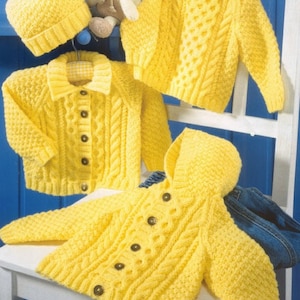May include: A set of three yellow knitted baby sweaters with cable knit patterns. The sweaters include a cardigan, a hooded cardigan, and a crew neck sweater. A yellow knitted hat with a pom pom is also included.