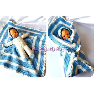 May include: A blue and white striped crocheted baby blanket with a white crocheted edging. The blanket is shown wrapped around a doll and laid flat.