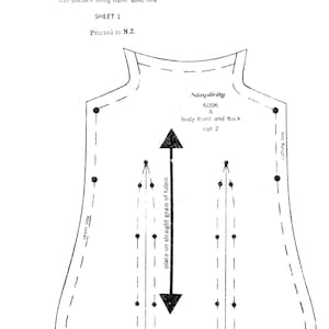 May include: A black and white sewing pattern piece for a Holly Hobbie rag doll, labeled 6006 A, showing the body front and back. The diagram includes a grain line arrow, dart markings, seam lines, cutting lines, and a ruler showing 2 inches.