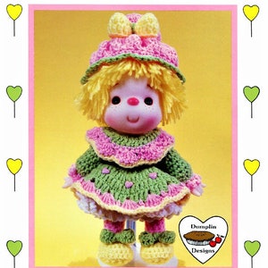 May include: A crochet doll with yellow hair, a pink and green dress, and a pink hat with a yellow bow. The doll is standing on a white surface. The text "Bubble Gum" is at the top of the image. The text "Brought to you directly from "Lollipop Lane"" is at the bottom of the image. The text "Dumplin Designs" is in a circle with a pie and cherries.