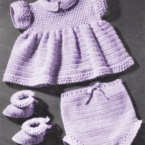 May include: A crocheted baby outfit in a light purple color. The outfit includes a dress with a peter pan collar, a pair of bloomers, and a pair of booties.