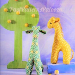 May include: Two plush giraffe toys, one green with a yellow diamond pattern and one yellow with a white dot pattern, stand near a green tree-shaped decoration with yellow spheres. The text "Past Patterns Palooza" is visible.