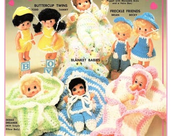 May include: A collection of small dolls with crocheted outfits and blankets, labeled as Collectables, Buttercup Twins Todd and Tammy, Wendy Wiggles, Freckle Friends Brian and Becky, Blanket Babies, Debbie Dreamer, Sally Slum, and Sally Slumbers.