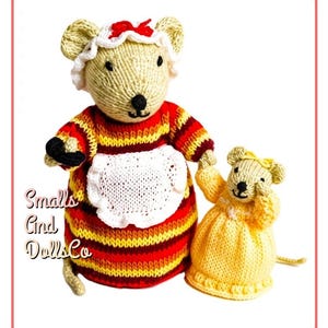 May include: Two hand-knitted mouse dolls with embroidered facial features. The larger mouse wears a red, orange, and yellow striped dress with a white apron and bonnet with a red bow. The smaller mouse wears a solid yellow dress. Text reads Smalls And DollsCo.