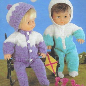 May include: Two knitted doll outfits, one in purple and white with a white pom-pom hat, and the other in blue and white with a white hooded hat. The dolls are sitting on a bench with a yellow kite.