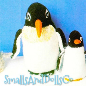 May include: Three knitted penguin toys. The largest penguin is white with a black head and orange beak. The middle penguin is white with a black head and orange beak. The smallest penguin is grey with a black head and orange beak.