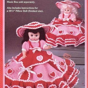 May include: Crochet pattern for a pink and red dress with white trim and heart accents. The dress is designed to fit a 13-inch Music Box Doll. The pattern also includes instructions for a 10 1/2-inch Pillow Doll.