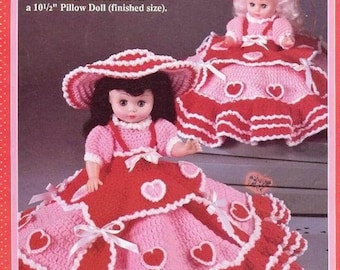 May include: Crochet pattern for a pink and red dress with white trim and heart accents. The dress is designed to fit a 13-inch Music Box Doll. The pattern also includes instructions for a 10 1/2-inch Pillow Doll.
