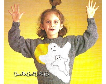 May include: A gray knitted sweater with a white ghost and yellow moon design. The sweater has a crew neck and long sleeves. The ghost has a smiling face and is holding a smaller ghost. The text "Small Crit Dolls Co." is visible on the sweater.