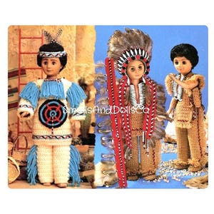 May include: Three crocheted dolls dressed in Native American attire. The doll on the left is wearing a blue and white shirt with a target design, tan pants, and blue fringe. The doll in the center is wearing a tan shirt, tan pants, a red and white headdress, and a long red and white feather boa. The doll on the right is wearing a tan shirt, tan pants, and a brown headdress.