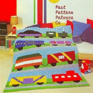 May include: A vibrant crocheted train blanket featuring train carriages in red, yellow, purple, green, and blue. The blanket has a blue sky backdrop and green grass at the base. The text "Past Pattern Palooza Co" is visible.
