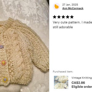 May include: A cream-colored knitted baby cardigan with a cable knit pattern and colorful buttons. The cardigan is laid flat on a white surface. The text "Vintage Knitting Pattern Baby Child Cable Aran S... CA$2.86 Eligible orders get 30% off" is visible below the cardigan.