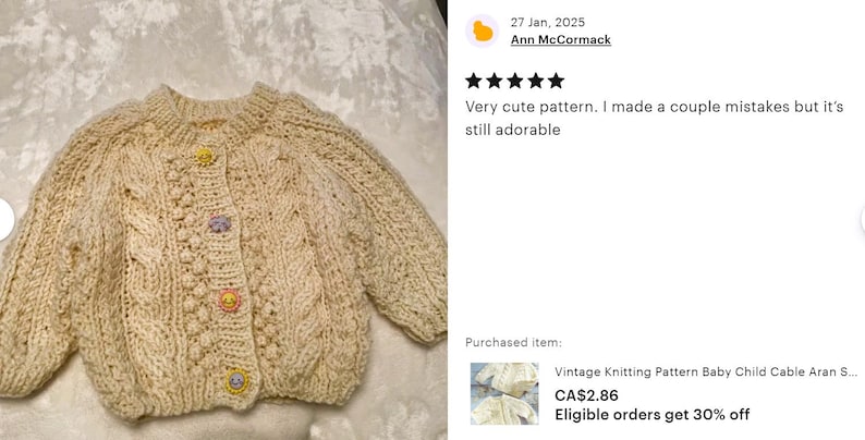 May include: A cream-colored knitted baby cardigan with a cable knit pattern and colorful buttons. The cardigan is laid flat on a white surface. The text "Vintage Knitting Pattern Baby Child Cable Aran S... CA$2.86 Eligible orders get 30% off" is visible below the cardigan.