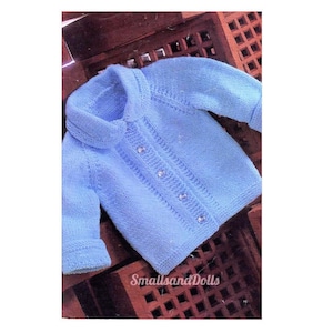 May include: A light blue knitted cardigan with a collar, button closure, and long sleeves. The cardigan is on a wooden surface.