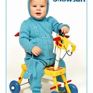 May include: A bright blue knitted snowsuit featuring an owl motif on the chest and a matching hood, accompanied by a blue knitted mitten. The text "Owl Snowsuit" is printed in blue in the upper right corner of the image.