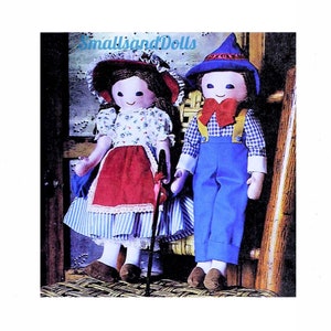 May include: Two handmade cloth dolls, a girl and a boy, are pictured together. The girl doll wears a floral dress, red apron, and a wide-brimmed hat. The boy doll is in blue overalls, a checked shirt, and a pointed hat. The text "smallsandDolls" is visible.