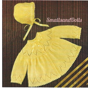 May include: A yellow knitted baby cardigan with a matching bonnet. The cardigan features a delicate lace pattern and a button fastening. The bonnet has a bow tied at the back. The text "SmallsandDolls" is visible in the image.
