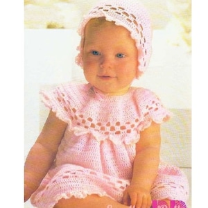 May include: A pink crocheted baby dress and bonnet set. The dress has a scalloped neckline and hem, and the bonnet has a scalloped edge.