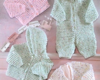 May include: Four knitted baby garments in pink, green, and white with a speckled pattern. The garments include a cardigan, a hooded jacket, a hooded jumpsuit, and a cardigan with a V-neck.