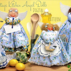 May include: Four vintage kitchen angel dolls made from blue and white striped fabric with floral accents. The dolls are dressed in different styles, including a dishtowel doll, a recipe clip doll, a doll with a basket, and a doll with pockets for coupons and spoons. The dolls are arranged on a table with lemons and a bottle of juice.