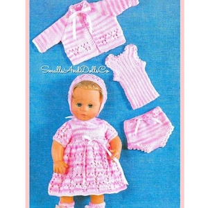 May include: A pink and white striped knitted doll outfit with a dress, cardigan, hat, tank top, and diaper. The outfit is designed for a doll with a size of approximately 12 inches. The doll is not included.