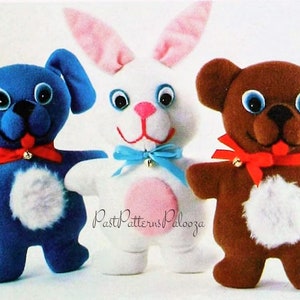 May include: Three plush toys: a blue dog, a white bunny with pink ears, and a brown bear. Each toy has large, white eyes, a white patch on its belly, and a red ribbon around its neck.