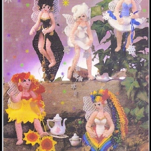May include: Five crocheted fairy dolls with wings and different colored dresses. The fairies are sitting on a rock with a teapot and a cup. The background is a purple and white starry sky.